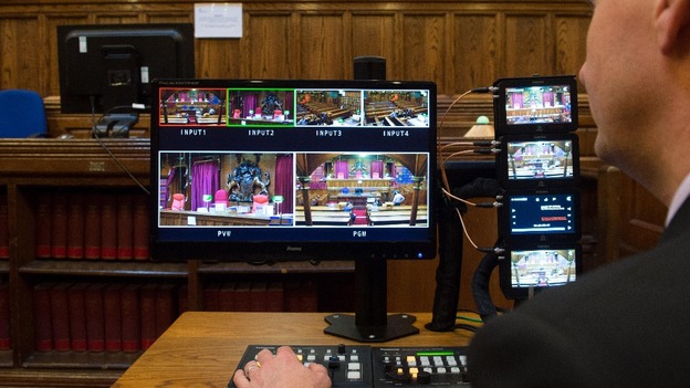 A man checks the monitors in Court Four at the Royal Courts of Justice in London.