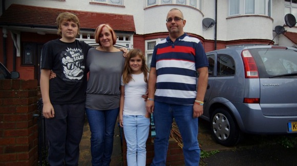 Family pose outside house