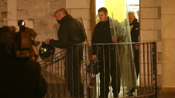 Police officers leave Maidstone Prison in Kent as the incident is taking place.