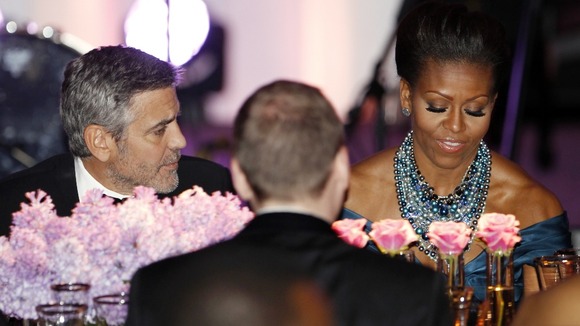 George Clooney sits beside Michelle Obama during the State Dinner for David Cameron in Washington in March.
