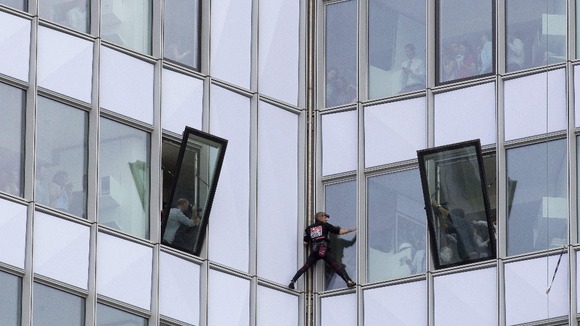 French urban climber Alain Robert, known as 'Spiderman', climbing up the 231 meter high (758 feet) First Tower