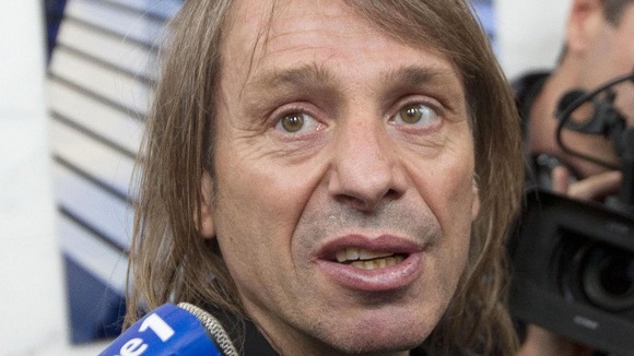 French urban climber Alain Robert, known as 'Spiderman', speaks to reporters after climbing up the 231 meter high (758 feet) First Tower