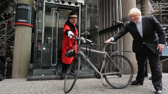 Boris Johnson holding a bike