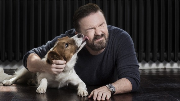 Ricky Gervais getting licked by a dog