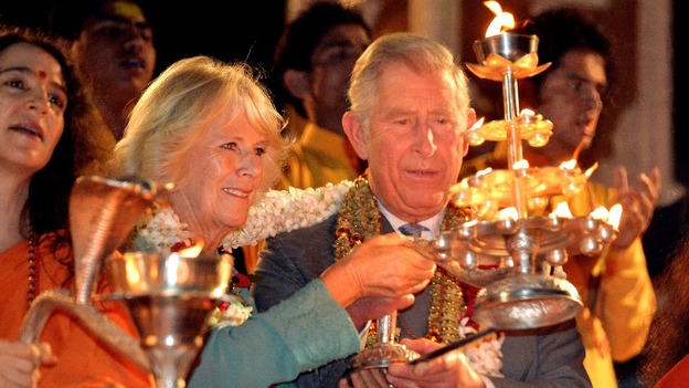 The Prince and Duchess light candles during a ceremony on the banks of the Ganges.