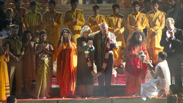 The Prince and Duchess were given a huge garland which covered them both.