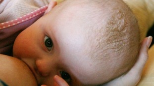 A baby being breastfed.