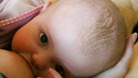 A baby being breastfed.