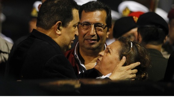 Venezuela's President Chavez greets his mother and brother upon arriving from Cuba at Simon Bolivar airport in Caracas