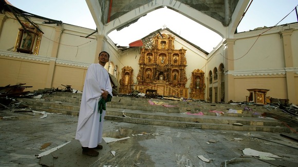 Catholic priest Father Martin stands in the destroyed Metropolitan Cathedral in the central Philippine city of Palo