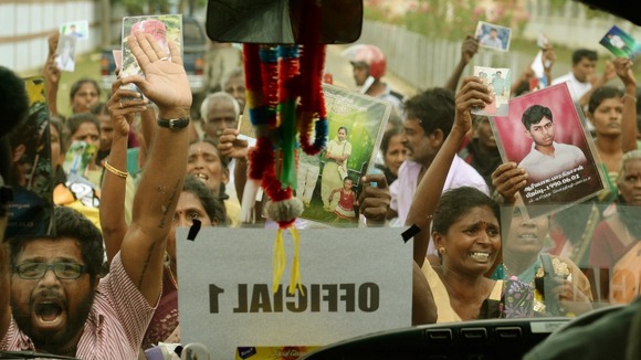 Tamil protesters hold up the Prime Minister's motorcade