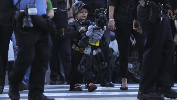 Miles carries his Batman balloon after the event.