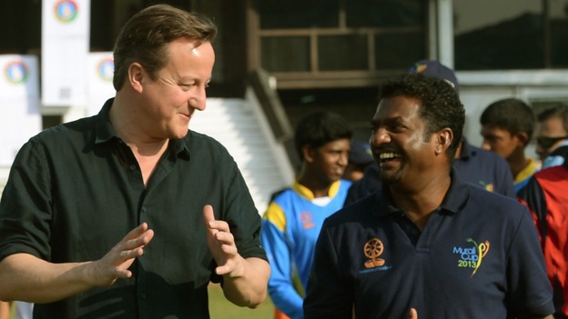 David Cameron chats to the former Sri Lankan cricketer Muttiah Muralitharan at Colombo's National Cricket Academy