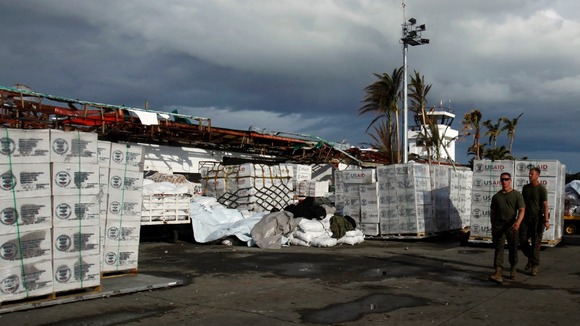 US servicemen walk past relief goods at Tacloban airport in the Philippines.