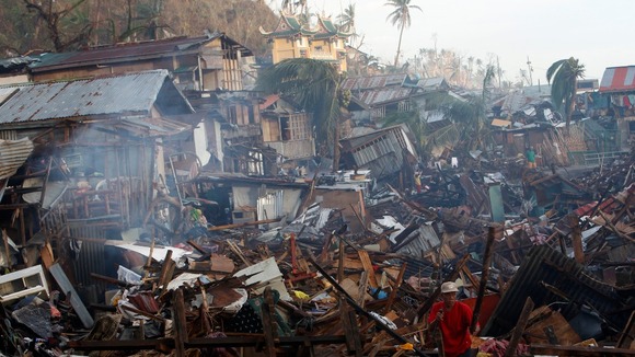 A man salvages debris following the devastation caused by Typhoon Haiyan in the Philippines.