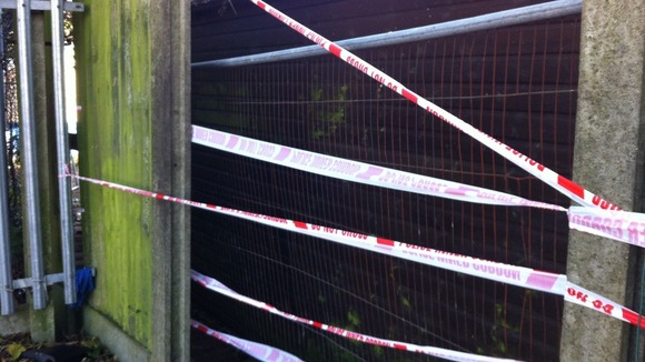 Police tape cordoning off the back of the property.