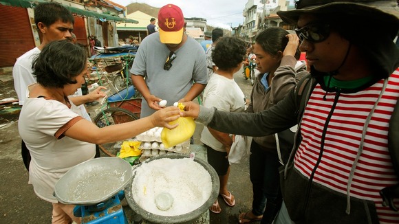 A woman sells salt and eggs along a main street in the Typhoon Haiyan devastated town of Palo, near Tacloban.