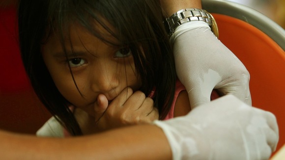A girl receives a Tetanus immunity injection at a church that became a homeless shelter in Tacloban.