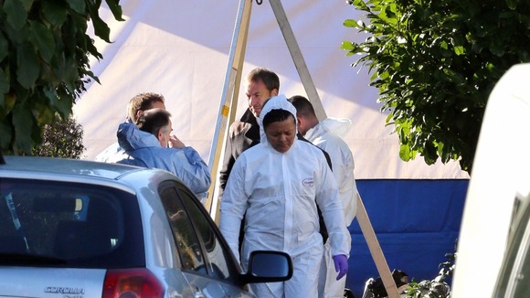 Forensics experts outside the home in Audley Drive, in Warlingham, Surrey.