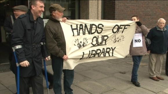 Campaigners waving home-made banners at Barnsley library