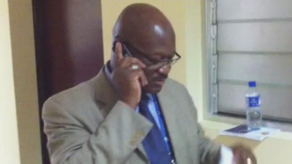 Media Spokesman Richard Uku pleading with aides to allow journalists press conference access.
