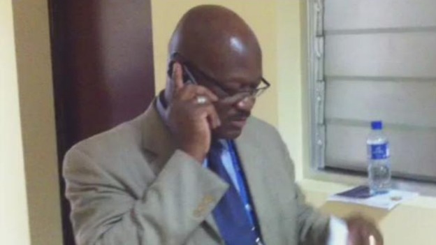 Media Spokesman Richard Uku pleading with aides to allow journalists press conference access.