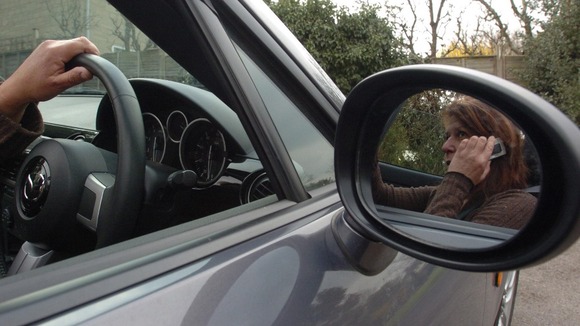 Woman on phone in car (posed by model)