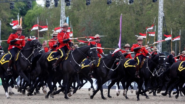 The Royal Canadian Mounted Police perform for Queen Elizabeth II at the Royal Windsor Horse Show at Windsor Castle, Berkshire