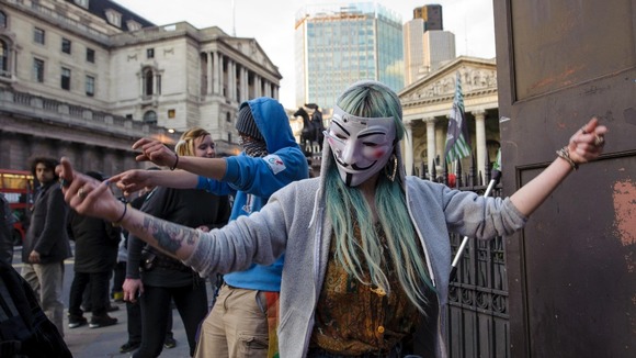 Occupy demonstrators dance near the Bank of England