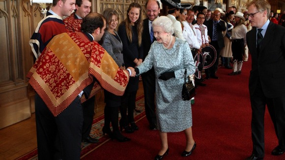Queen Elzabeth II meets Huasos riders and dancers from Chile during a tea party for the cast of the Diamond Jubilee Pageant at Windsor