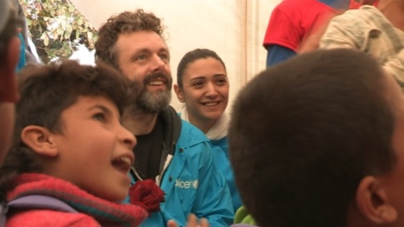 Michael Sheen joins in with children singing at a makeshift school in Lebanon
