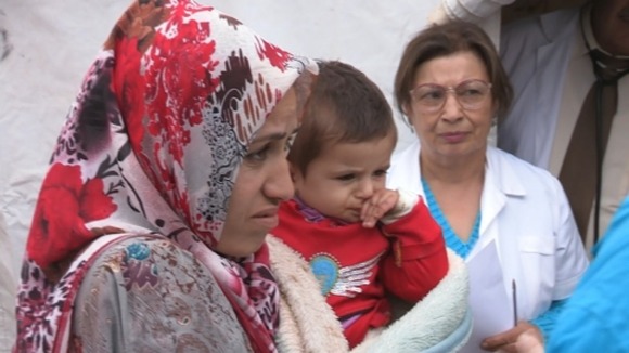 A woman and child Michael Sheen met at a field clinic at the camp