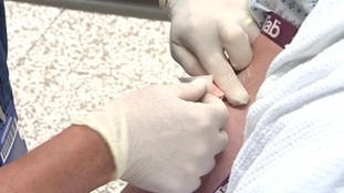 Nurse injecting patient
