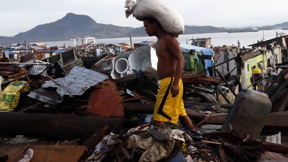 A Typhoon Haiyan survivor picture today in the devastated Tacloban city.