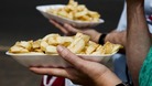 People eating chips on a British promenade