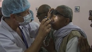 Dr Geoffrey Tabin examines a patient for cataracts