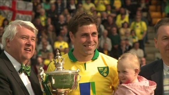 Norwich City captain Grant Holt poses with Barry Butler Memorial Trophy with chairman Alan Bowkett