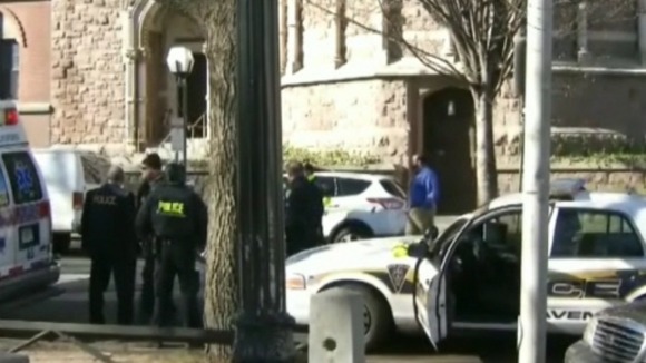 Police vehicles and an ambulance nearby the scene.
