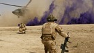 British soldiers cover themselves from dust as a helicopter lands in Helmand