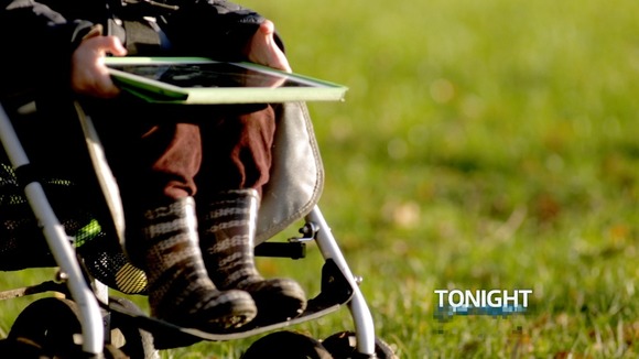 toddler in pram with tablet