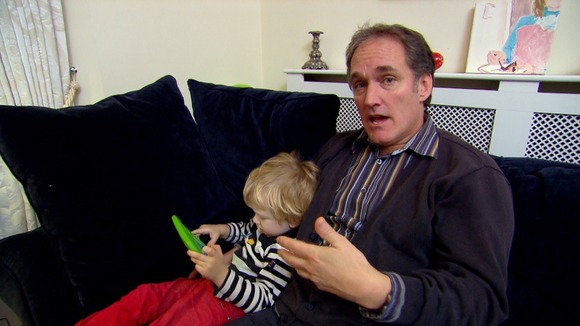 Man with boy on sofa
