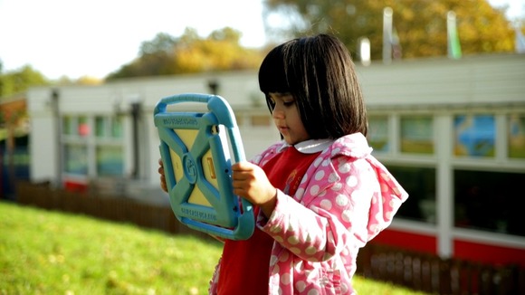 young girl looking at tablet