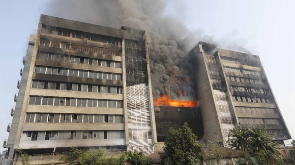 Smoke rises from a fire burning at a Standard Group garment factory in Gazipur