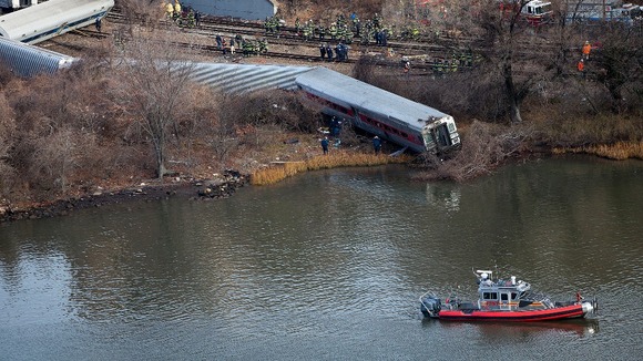 Emergency workers gather at the site of a Metro-North train derailment in the Bronx borough of New York.