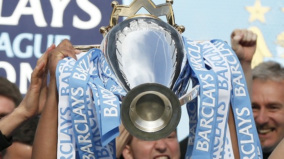 Vincent Kompnay holds aloft the Premier League trophy