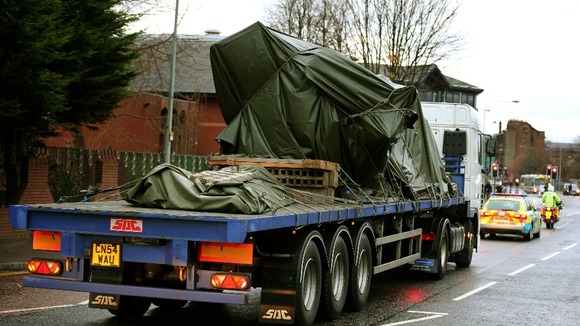 The wreckage of the police three-tonne Eurocopter is driven away