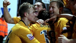 Luke Berry is smothered by his team-mates after scoring the winner.