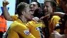 Luke Berry is smothered by his team-mates after scoring the winner.