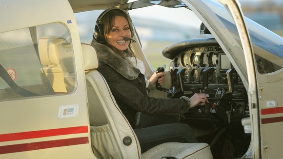 Loose Woman Carol Vorderman pictured in the pilot's seat of a light aircraft.