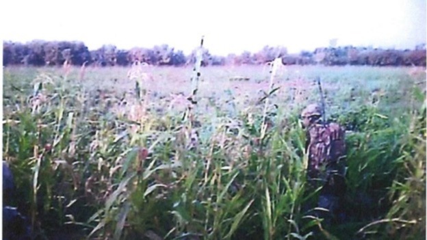 A commando is seen to the right of the helmet camera footage.